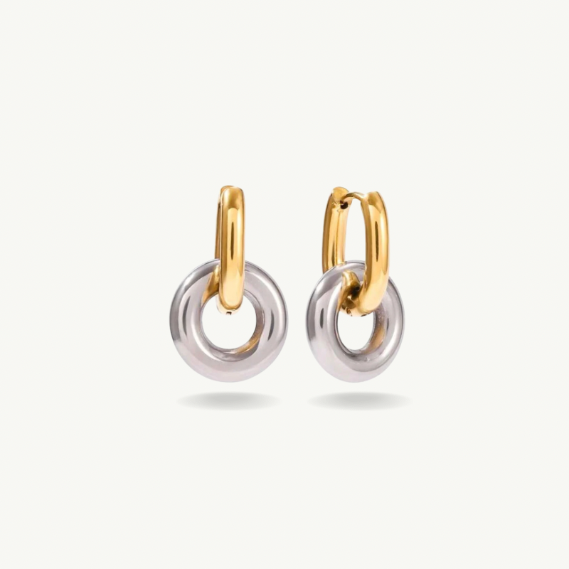 A pair of gold and silver hoop earrings with interlocking circular drop elements, shown on a clean off-white background.