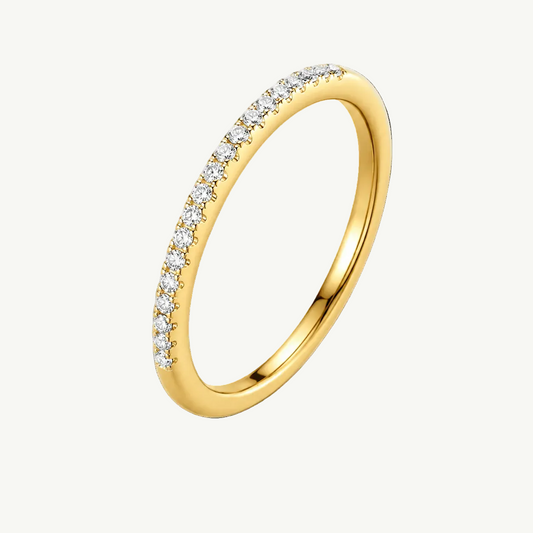 A yellow gold eternity ring featuring a single row of round-cut clear gemstones in a prong setting, shown on a clean white background.