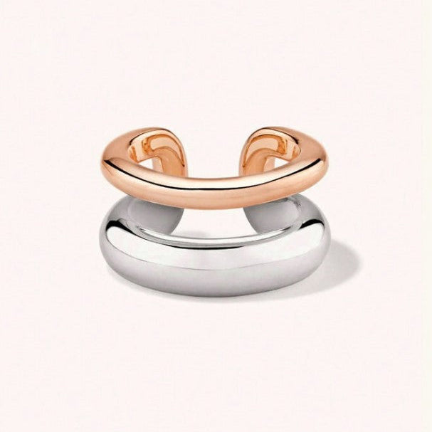 A two-tone minimalist ring with a polished rose gold upper band and a larger, smooth silver dome base, shown on a clean off-white background.