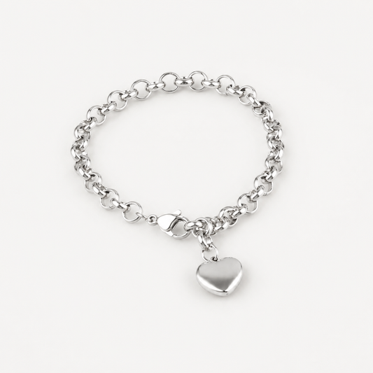 A silver chain bracelet with a polished heart-shaped charm, displayed on a clean, light off-white background.