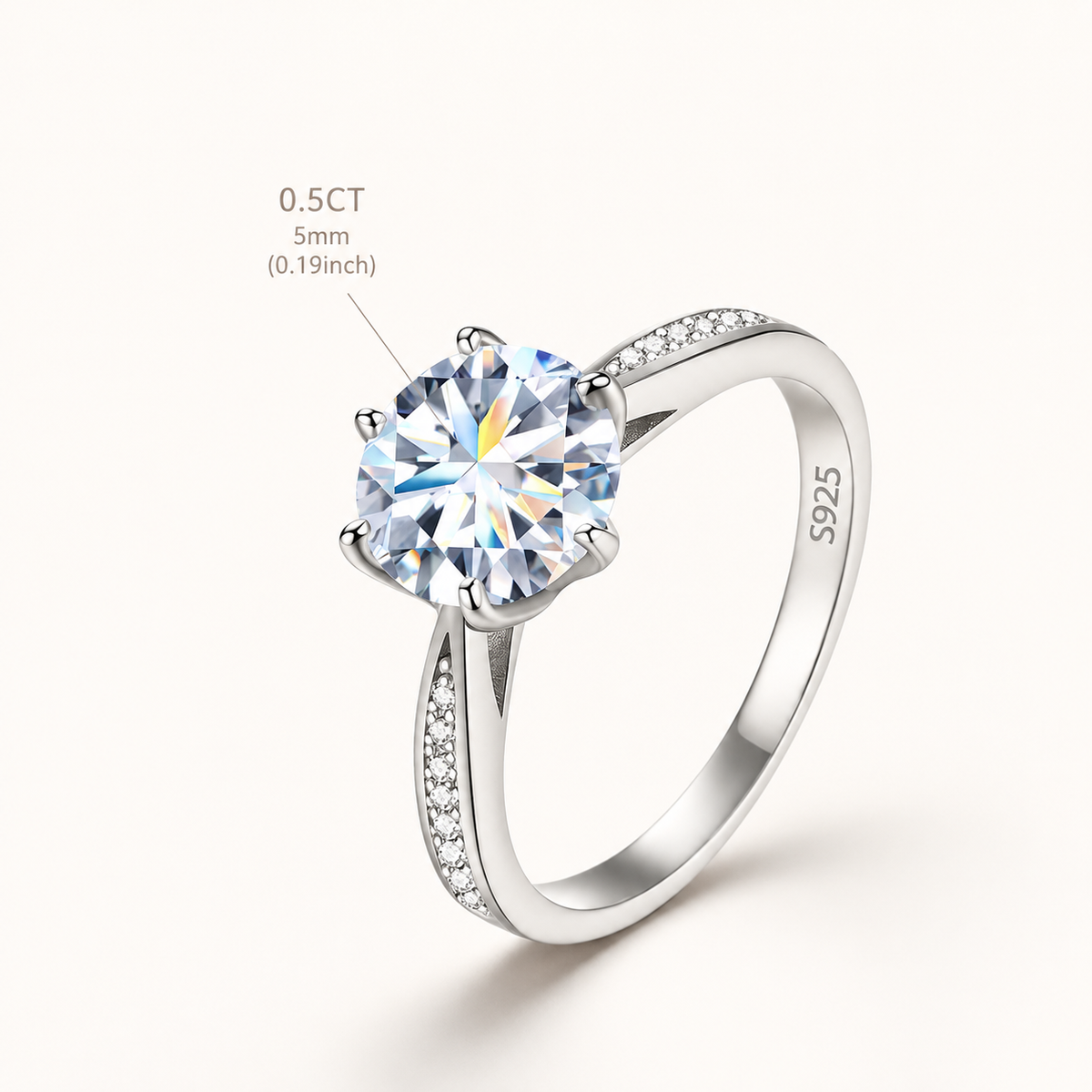 A silver solitaire engagement ring with a round brilliant-cut clear gemstone and a pavé-set band, shown on a light cream background with a size and carat callout overlay.